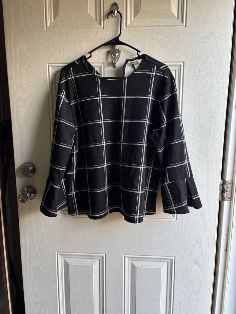 H&M Black Blouse with White Windowpane Stripes and wide sleeves.